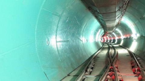Tunnel with aqua walls and tracks on ground